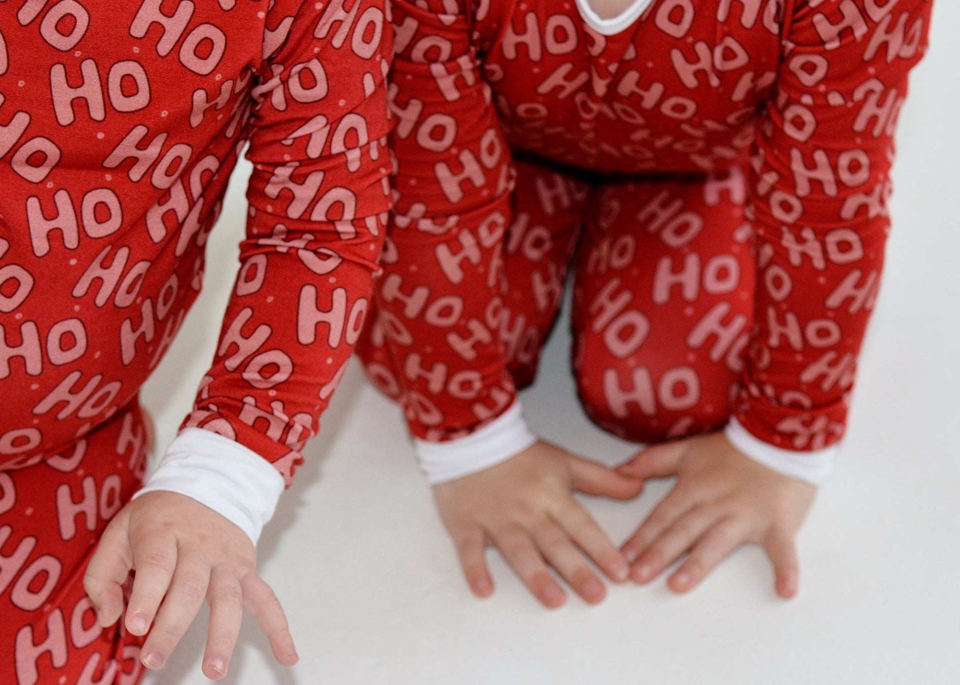 Toddler in red Ho Ho Ho bamboo Christmas pajamas — breathable hypoallergenic holiday sleepwear | AddieGrey & Co