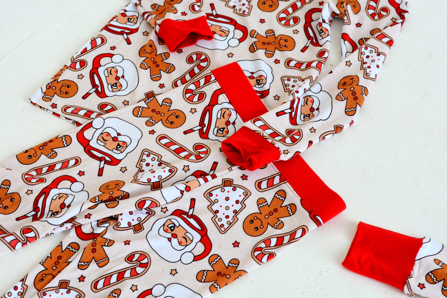 Child laughing in Gingerbread Santa bamboo Christmas pajamas — breathable holiday sleepwear for babies and toddlers | AddieGrey & Co